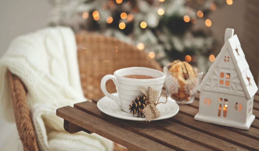 Christmas season decoration, cup of coffee on wooden coffee table