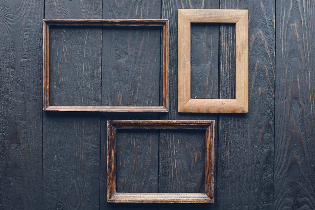 Wooden frames on old wooden wall