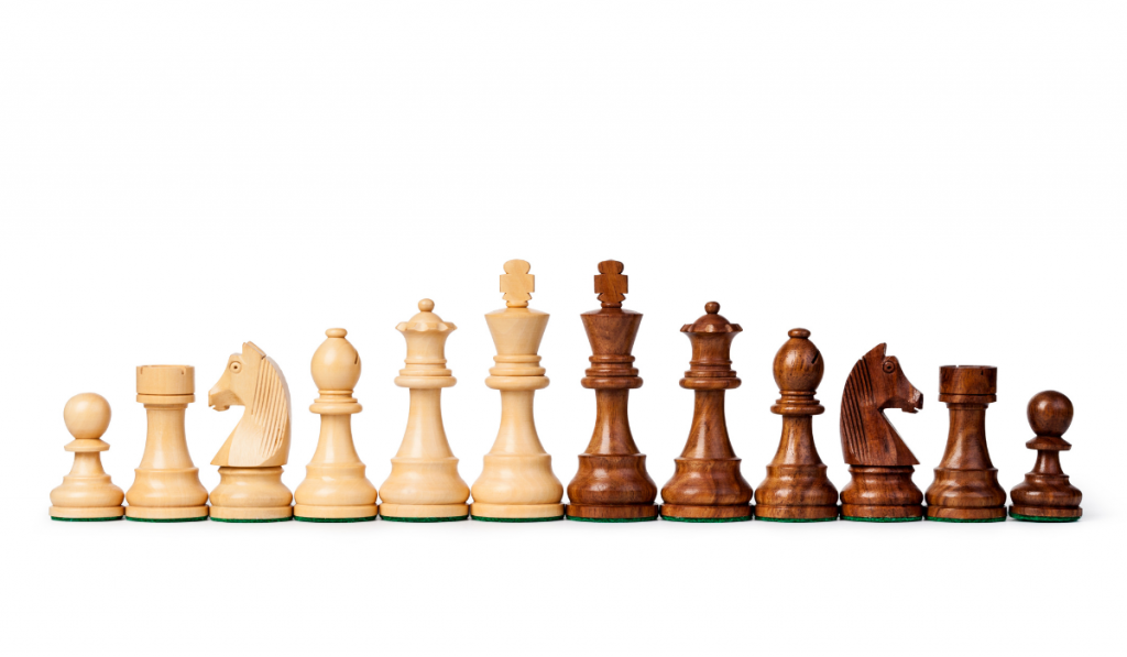 wooden chess pieces on a white background
