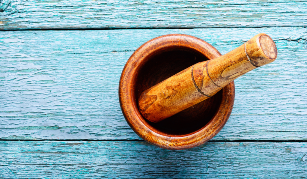 Empty wooden mortar and pestle on wooden old background

