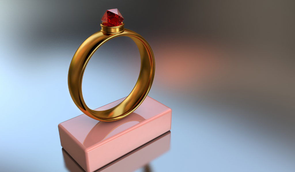  gold ring with a big red diamond 