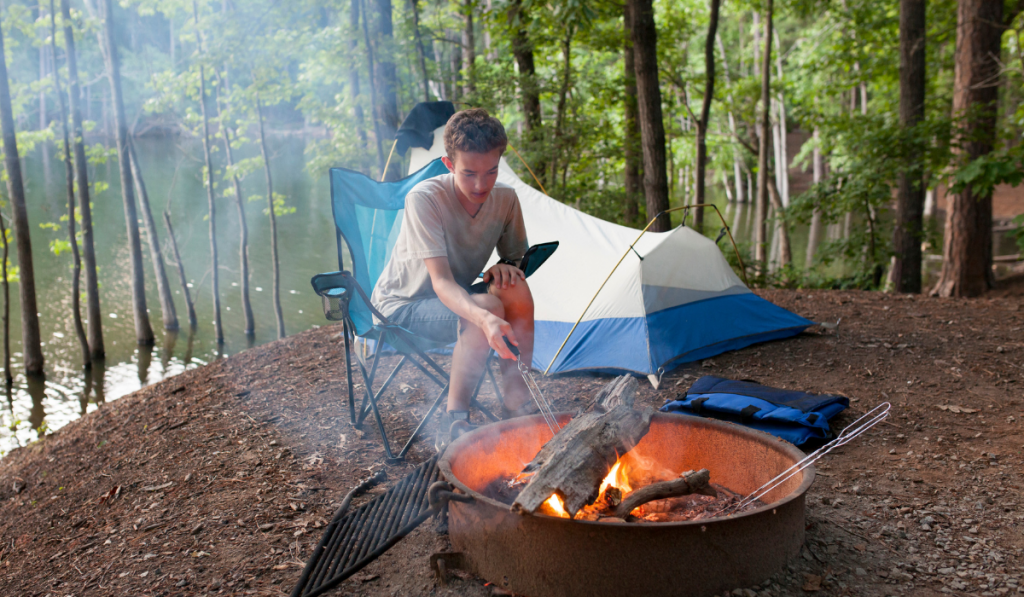 teenager camping with camp fire
