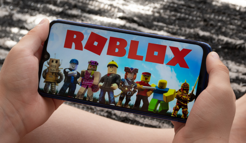 Boy play Roblox at smartphone