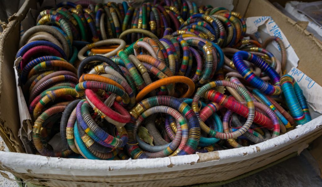 multicolor silk thread bangles kept together for sale in a box